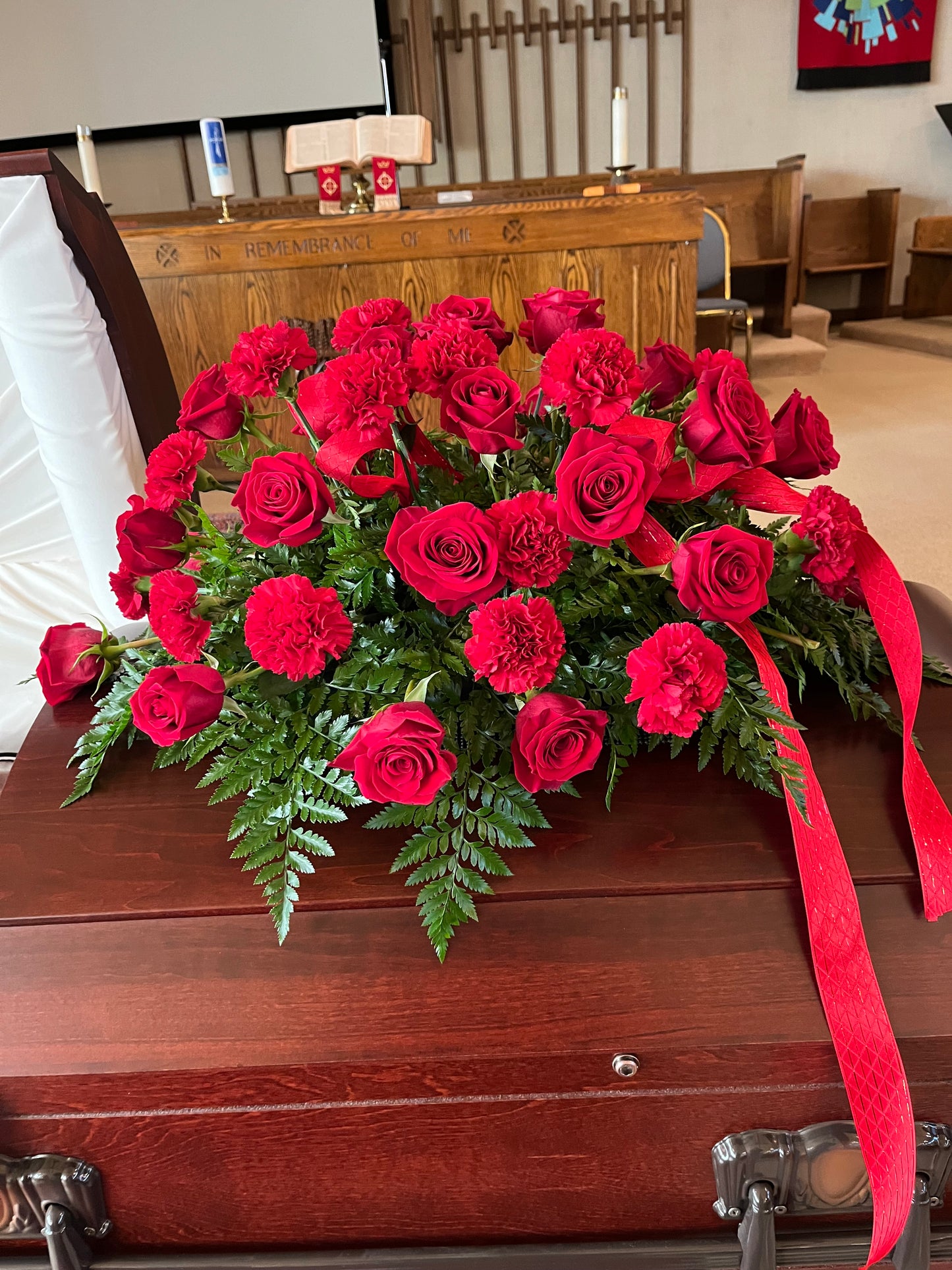 Red rose and carnation casket spray