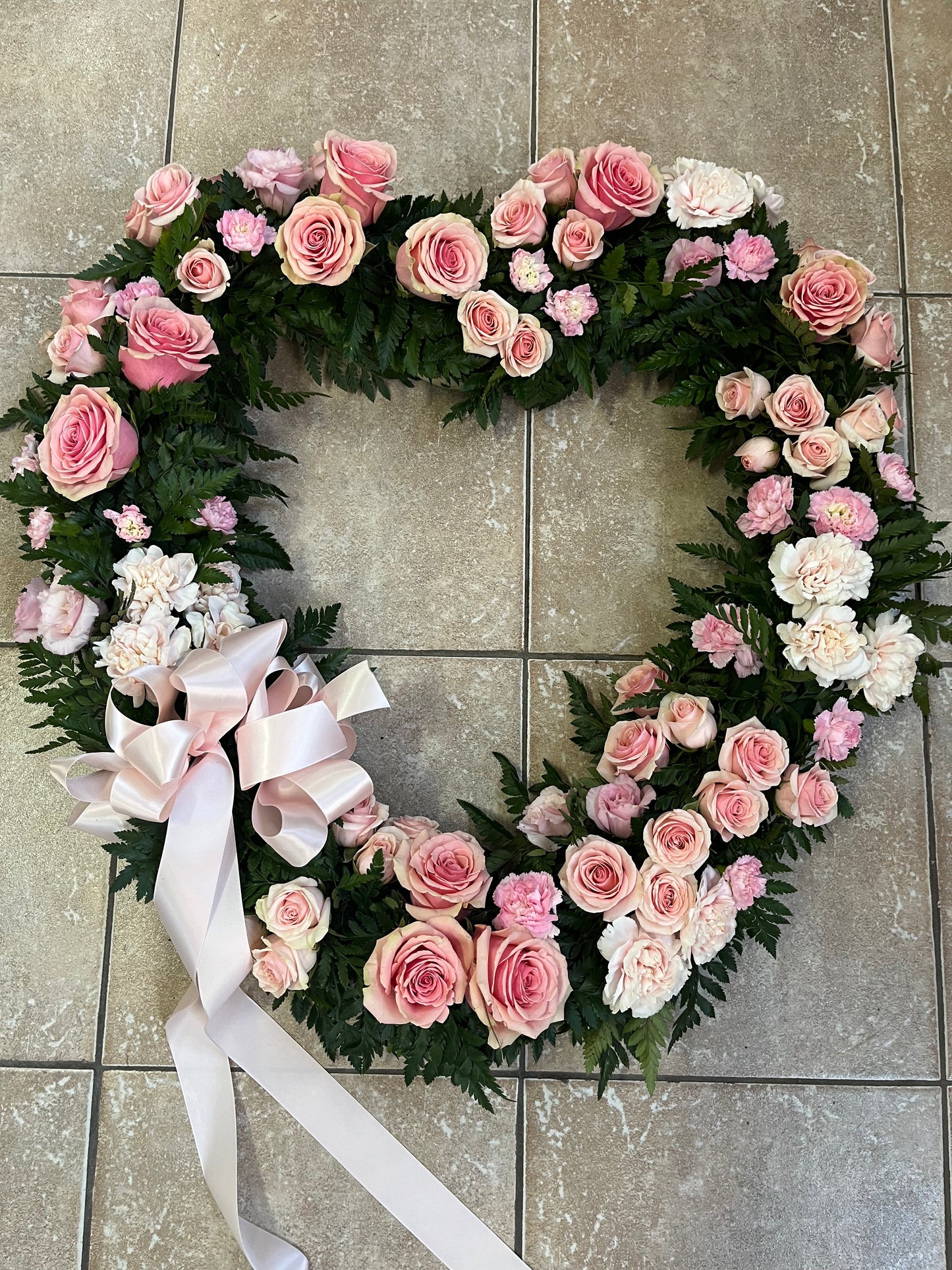 Classic pink heart funeral flower tribute