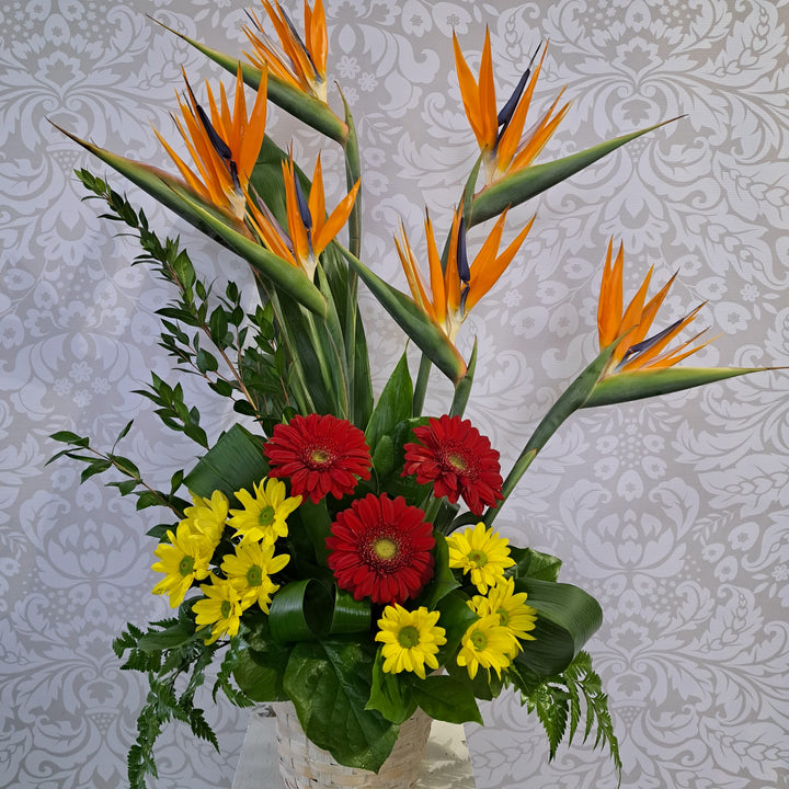 Tropical funeral flower arrangement with fresh blooms