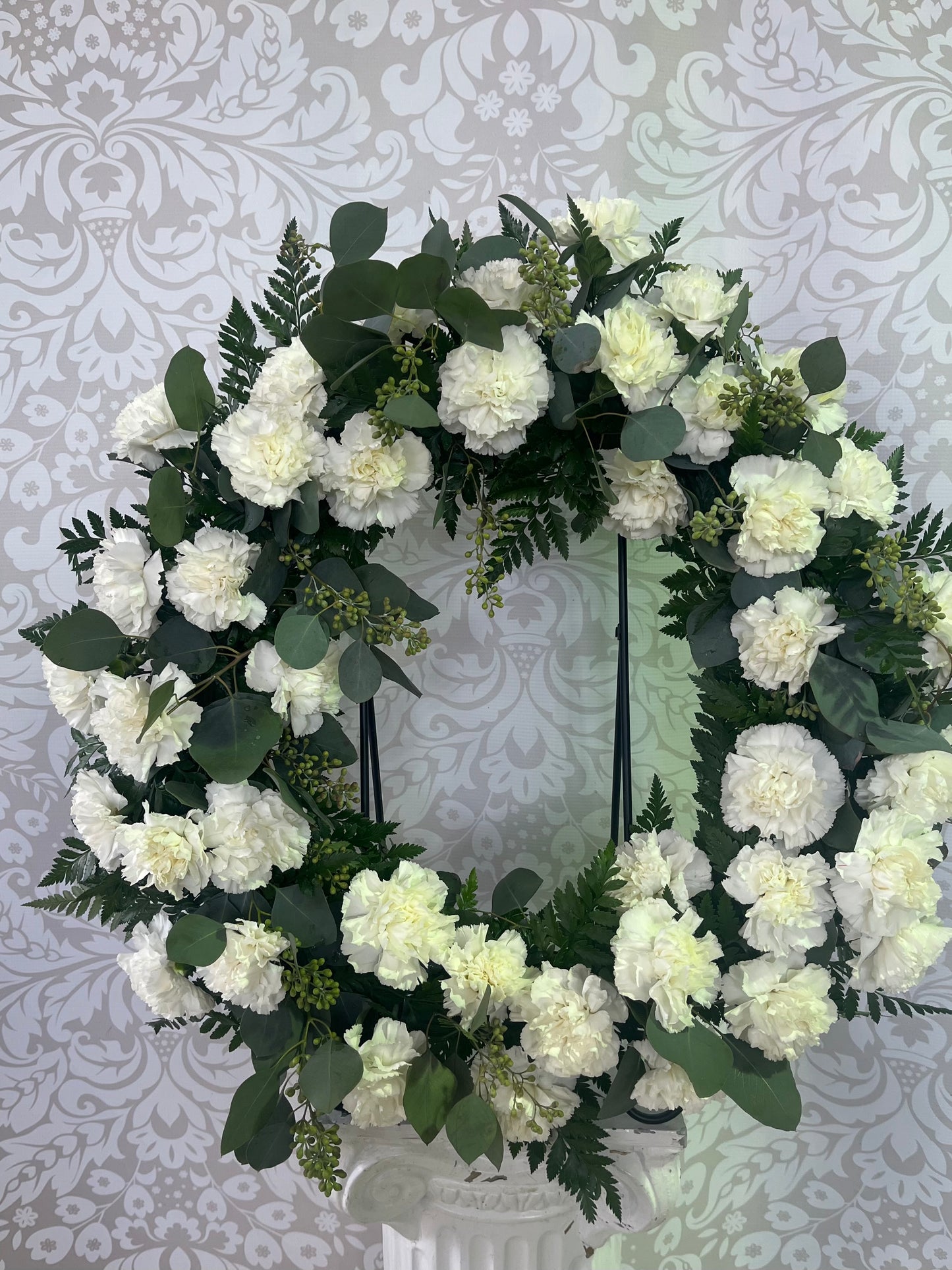 Luscious white carnations & eucalyptus wreath