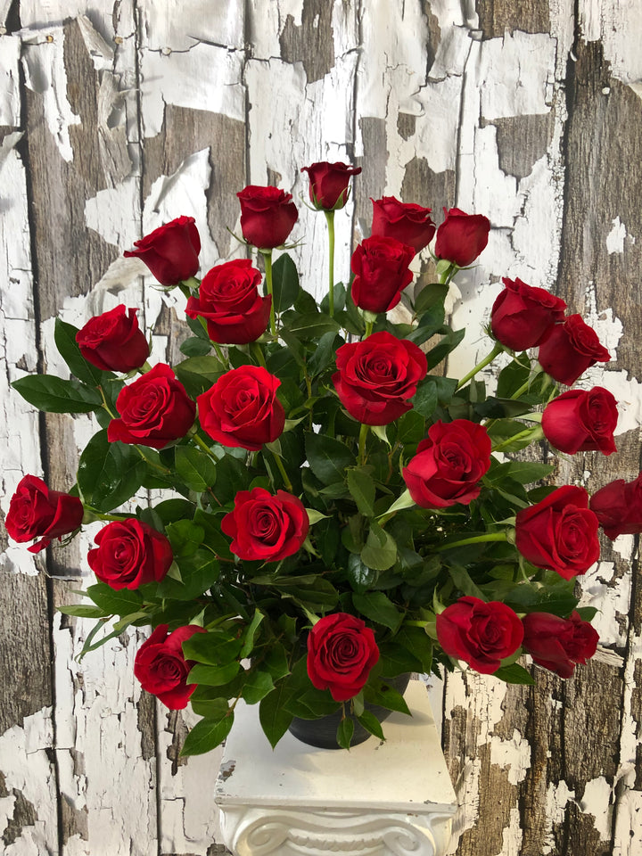 Bouquet of red roses against a textured wooden background