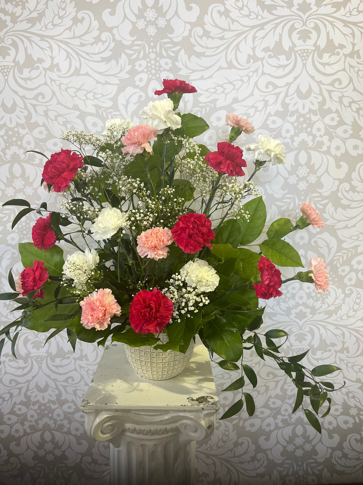 Traditional funeral flower arrangement with fresh blooms