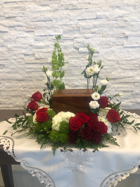 Red rose urn arrangement with white hydrangeas, lisianthus, and greenery