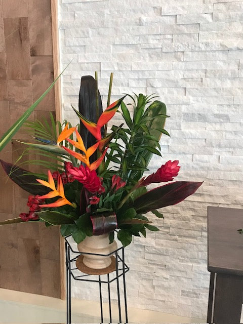 Tropical sympathy plant arrangement with bird of paradise, red ginger, and greenery
