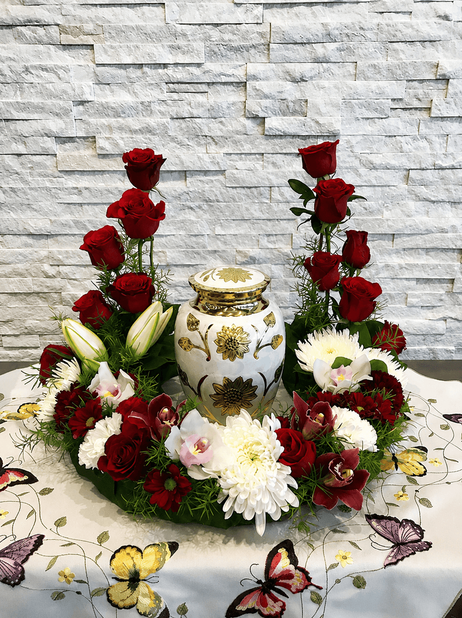 Red rose and white flower urn arrangement with lilies, orchids, and greenery